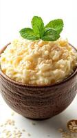 Creamy cottage cheese topped with fresh mint leaves in a rustic bowl on a bright background photo