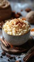 Delicious creamy rice pudding garnished with spices on a rustic wooden surface in a cozy kitchen setting photo