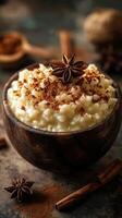Creamy rice pudding served in a rustic bowl with spices on a wooden table during a cozy evening photo