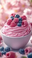 Delicious dessert featuring whipped raspberry and blueberry topping in a bowl with floral background photo