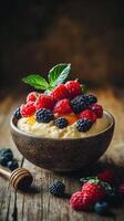 Creamy dessert topped with fresh red and black berries served in a rustic bowl on a wooden table photo