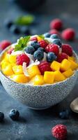 Delicious fruit and chia seed bowl topped with colorful berries and fresh mango photo