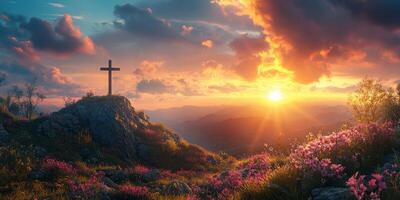 Sunset over a serene mountain landscape with a cross and blooming flowers photo