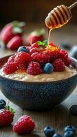 Delicious dessert featuring creamy yogurt topped with fresh berries and honey on a rustic wooden table photo