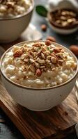Delicious bowl of creamy rice pudding topped with a mix of nuts and seeds served in a cozy kitchen setting photo