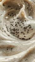 Creamy mixture with scattered seeds showcasing texture and swirl pattern in a culinary setting photo