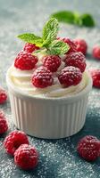 Delicious raspberry dessert topped with fresh mint and powdered sugar on a textured surface photo