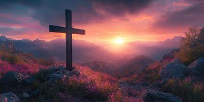 Mountain landscape with a wooden cross at sunset glowing behind the hills photo