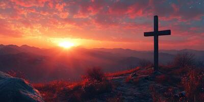Sunset view over mountains with a wooden cross on a hilltop and vibrant clouds in the background photo