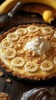Delicious banana cream pie topped with bananas and whipped cream on a rustic wooden table photo