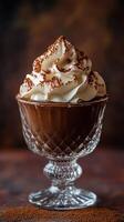 Delicious chocolate mousse topped with whipped cream and cocoa powder in an elegant glass dessert dish photo