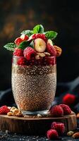 Chia pudding topped with fresh raspberries, banana slices, and mint leaves on a wooden base photo