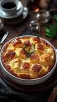 Savory bread pudding topped with caramelized crust and fresh thyme on a rustic wooden table photo