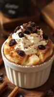 Creamy bread pudding topped with whipped cream and raisins served in a rustic kitchen photo