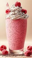 Delicious raspberry shake topped with whipped cream and chocolate sprinkles ready to enjoy photo