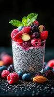 Delicious chia pudding topped with fresh berries and nuts on a dark background photo