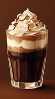 Creamy dessert beverage with layers of chocolate and whipped cream served in a clear glass photo