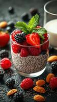 Healthy chia seed pudding topped with fresh berries and mint on a dark textured surface photo