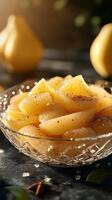 Deliciously sweet pear dessert garnished with spices in a crystal bowl on a wooden table photo