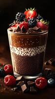 Delicious chocolate dessert with berries and chocolate shavings in a glass on a dark background photo