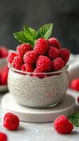Delicious raspberry chia pudding topped with fresh berries and mint leaves in a stylish setting photo