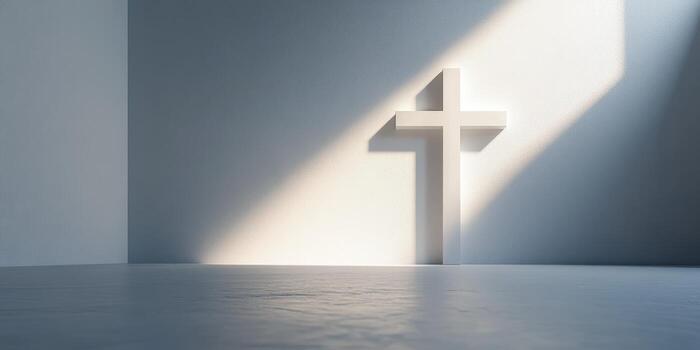 Light shines on a minimalist cross in a serene interior space during daytime photo