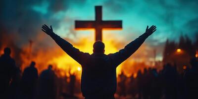 Worshippers gather at dusk to celebrate faith and unity during an outdoor service with a large cross in the background photo