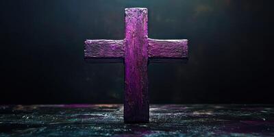 Symbolic wooden cross illuminated by purple light, creating a dramatic atmosphere for reflection photo