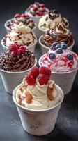 Delicious variety of whipped cream desserts with fruits and toppings displayed in cups at a dessert shop photo