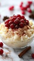 Delicious dessert featuring creamy rice pudding topped with fresh red currants and spices served in a clear bowl photo