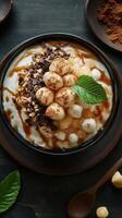 Delicious dessert bowl topped with cream, chocolate, and nuts perfect for an evening treat photo