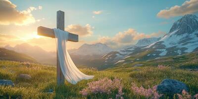 Cross draped with white cloth in serene mountain landscape at sunset photo