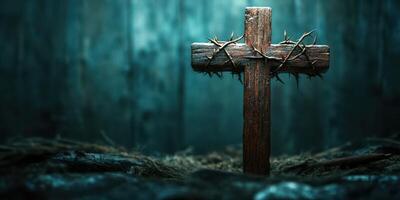 Wooden cross surrounded by thorns in a dimly lit setting evokes deep reflection during a solemn moment photo