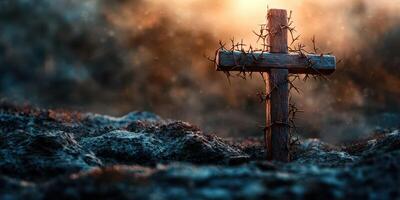 Cross adorned with thorns stands firm against a dramatic sunset backdrop in a serene landscape setting photo