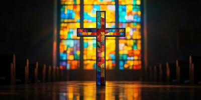 Colorful stained glass cross illuminated in a serene church setting during early morning light photo