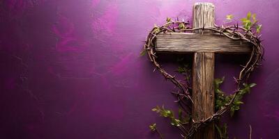 Rustic heart-shaped cross with thorns and greenery against a purple wall photo