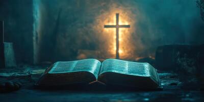 Open book with illuminated cross in dimly lit space during evening hours photo