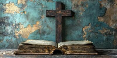 Old book with weathered pages and wooden cross placed on a rustic surface photo
