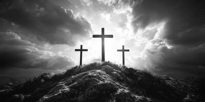 Three wooden crosses silhouetted against a dramatic sky during sunset in a quiet landscape photo
