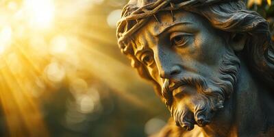 Statue of a religious figure with emotional expression under warm sunlight in a serene outdoor setting photo