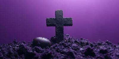 Mysterious black cross and egg surrounded by dark soil under a purple light in a surreal setting photo