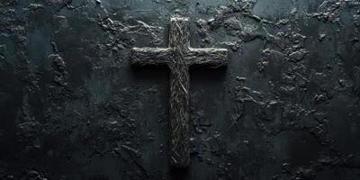 Cross made of intertwined materials against a dark, textured background creates a striking visual representation of faith photo