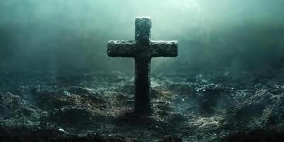 Dark graveyard with a weathered cross emerging from foggy earth at dawn photo