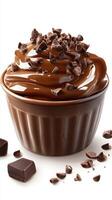 Rich chocolate mousse topped with chocolate shavings in a small bowl on a bright background photo