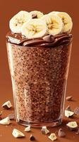 Creamy chocolate banana smoothie with rich toppings served in a transparent glass on a warm background photo