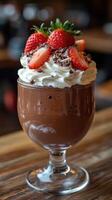 Decadent chocolate dessert topped with strawberries and whipped cream served in a restaurant setting photo