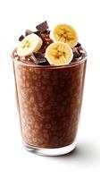 Chocolate chia pudding topped with fresh banana slices and chocolate pieces served in a clear glass cup photo