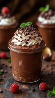 Delicious chocolate mousse dessert served in a jar topped with whipped cream and chocolate shavings photo