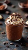 Creamy chocolate mousse topped with whipped cream and chocolate shavings in a glass jar photo