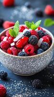 Fresh berry salad featuring raspberries, blackberries, and blueberries served in a textured bowl with mint accents photo